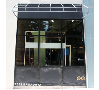 Black anodized aluminum storefront with beaded finish panels below & faux canopy frame above