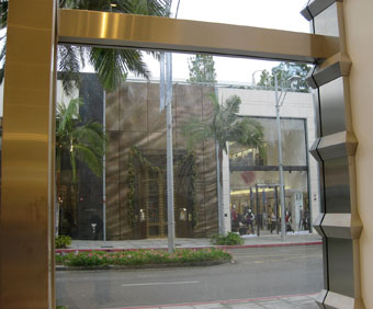 The ribbed cladding “passes through” the storefront glass into the store interior.