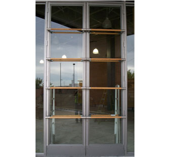 Aluminum and glass storefront doors with 4 rows of horizontal wood dowel pulls