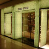 Custom pattern film on glass storefront panels with polished stainless steel framing & polished brass detailing