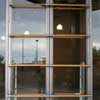 Aluminum and glass storefront doors with 4 rows of horizontal wood dowel pulls.